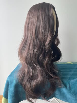 Real product photo of long wavy synthetic wig side view in natural light