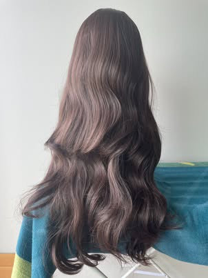 Real product photo of long wavy synthetic wig back view in natural light