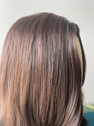 Real product photo showing synthetic wig color texture and smooth hair detail in natural light